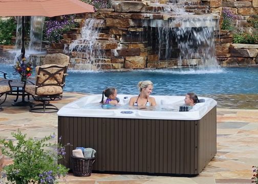 a mother and children having family fun in a hot tub
